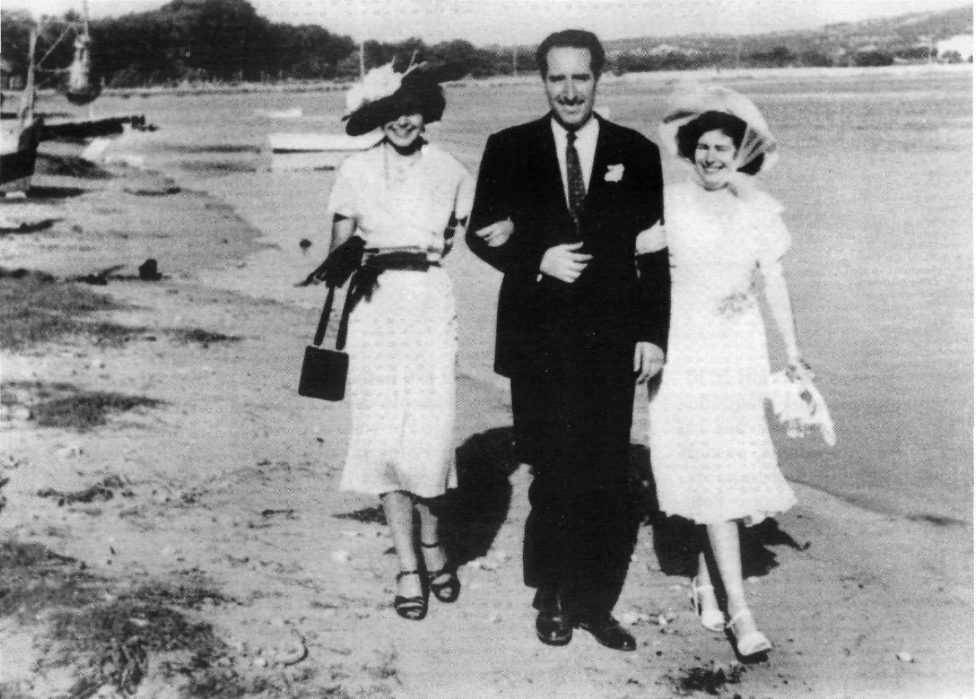 Man walking with two women on a beach