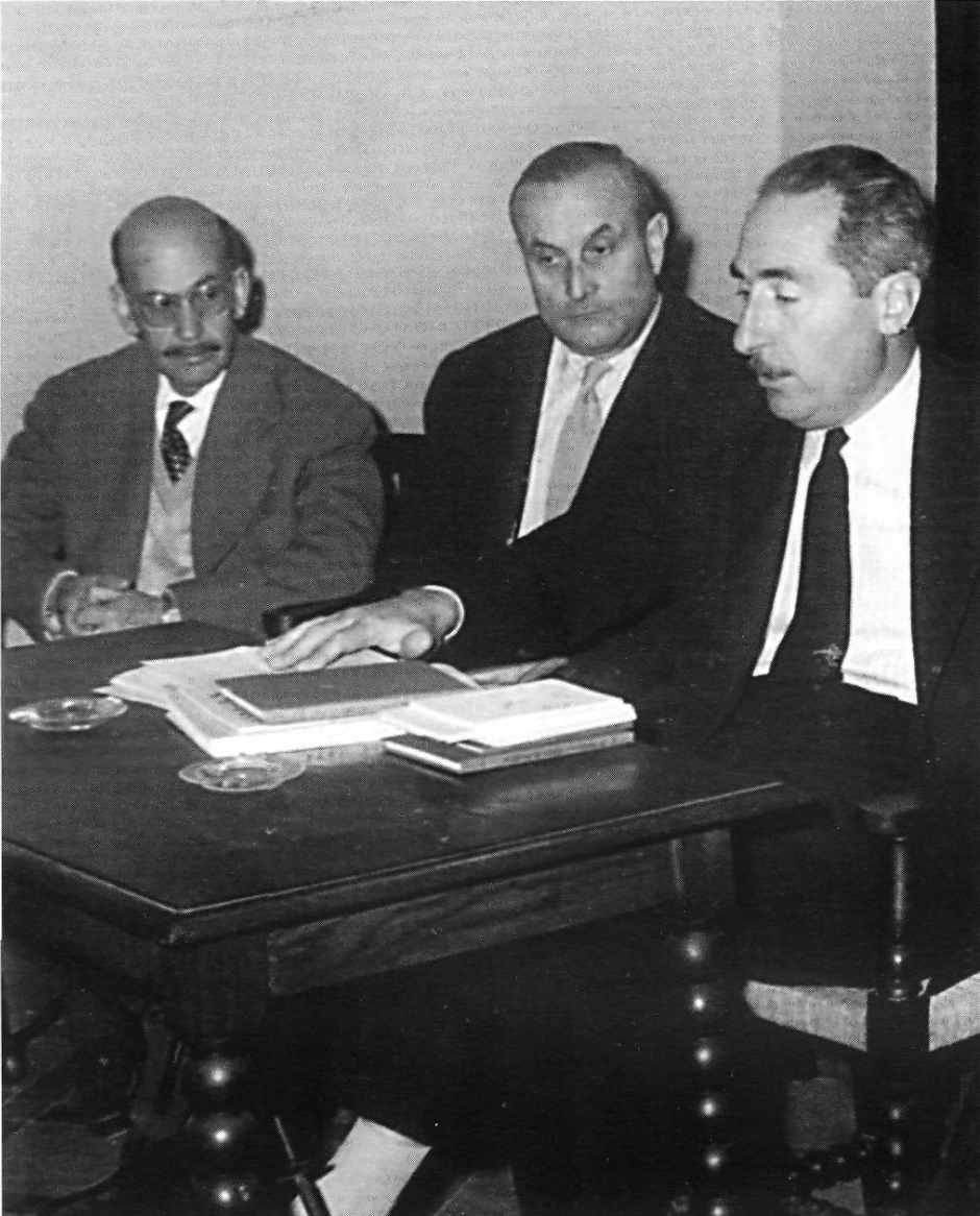 Three men sitting at a table