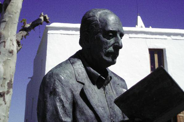 Bust d'un home davant d'un edifici blanc