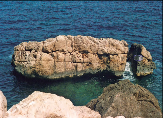 A la dreta, na Xapada, un escull situat a la cala d'Albarca, a la costa mateuera.