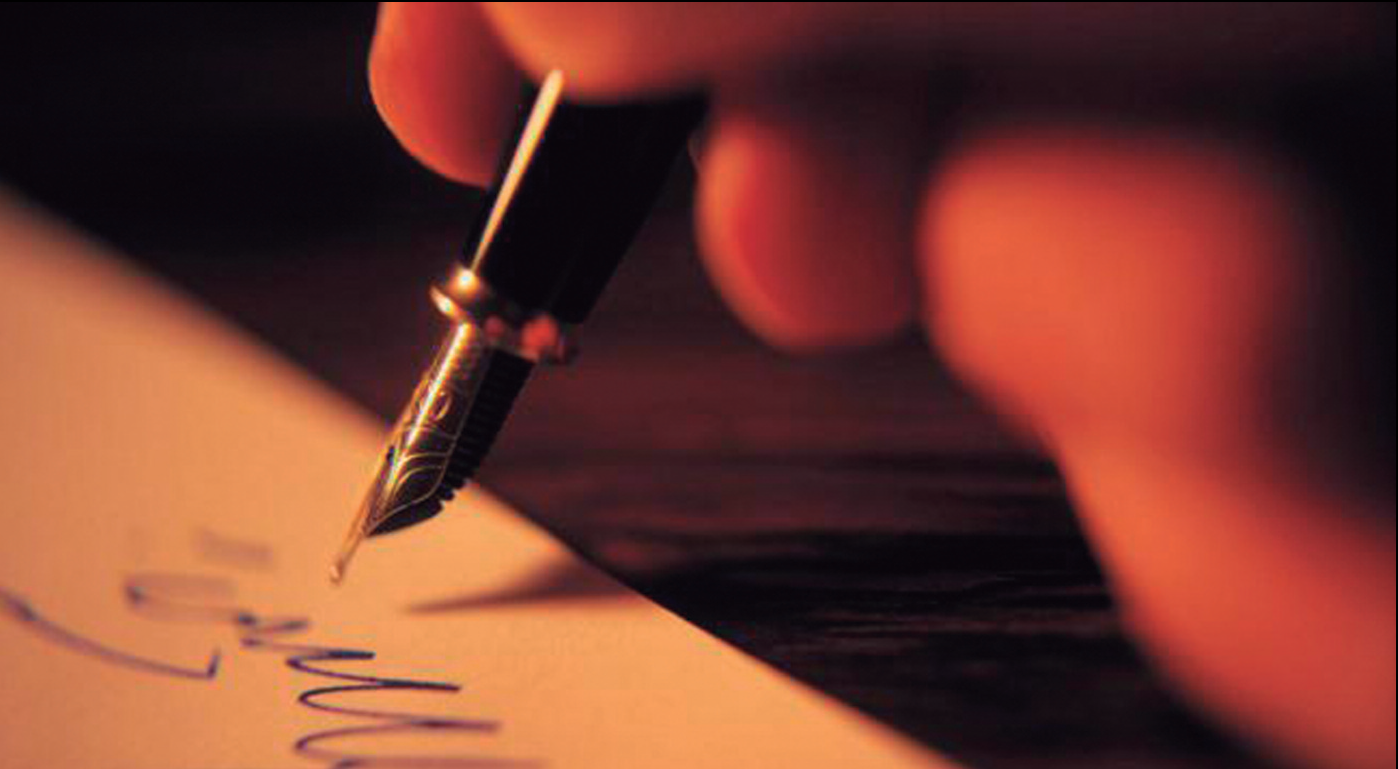 Image of a hand writing with a fountain pen