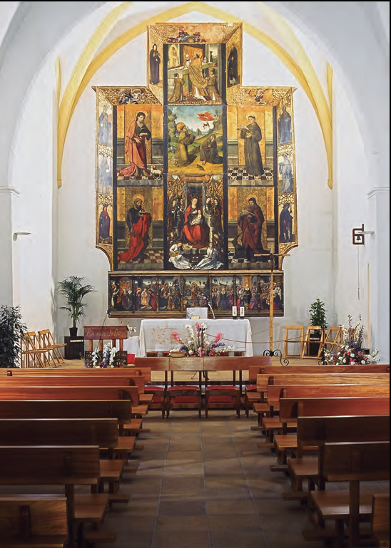 Interior de l'església, amb el retaule al fons, baix de la volta de creueria aixecada el 1549 (foto: Vicent Marí).